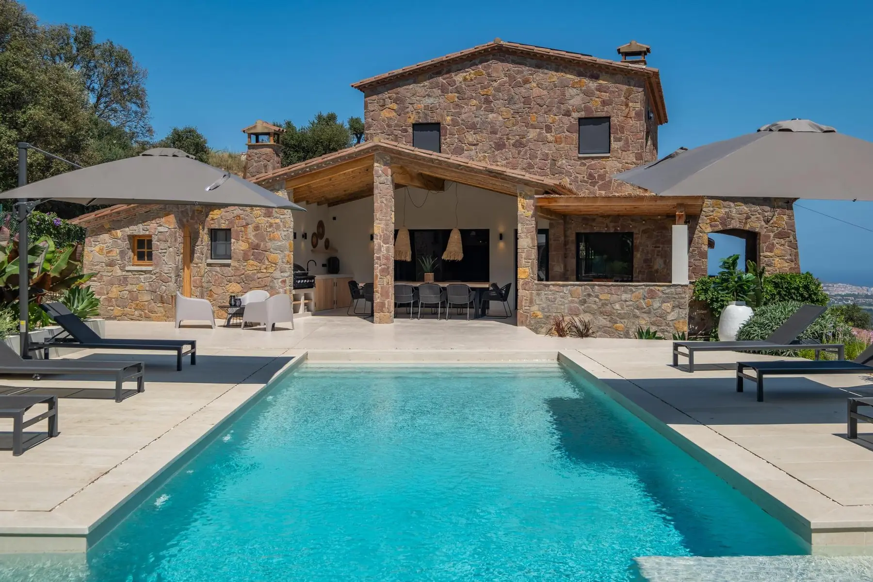 A stone villa with its pool